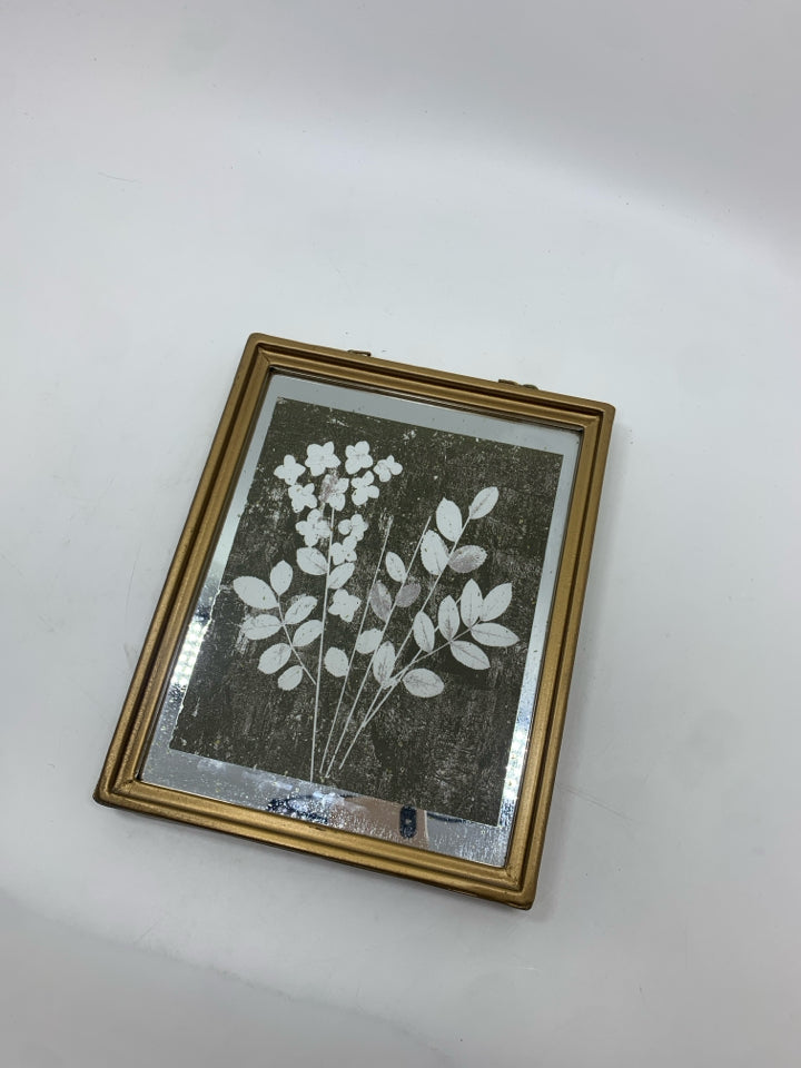 WHITE FLORAL PRINT IN HANGING BRASS FRAME.