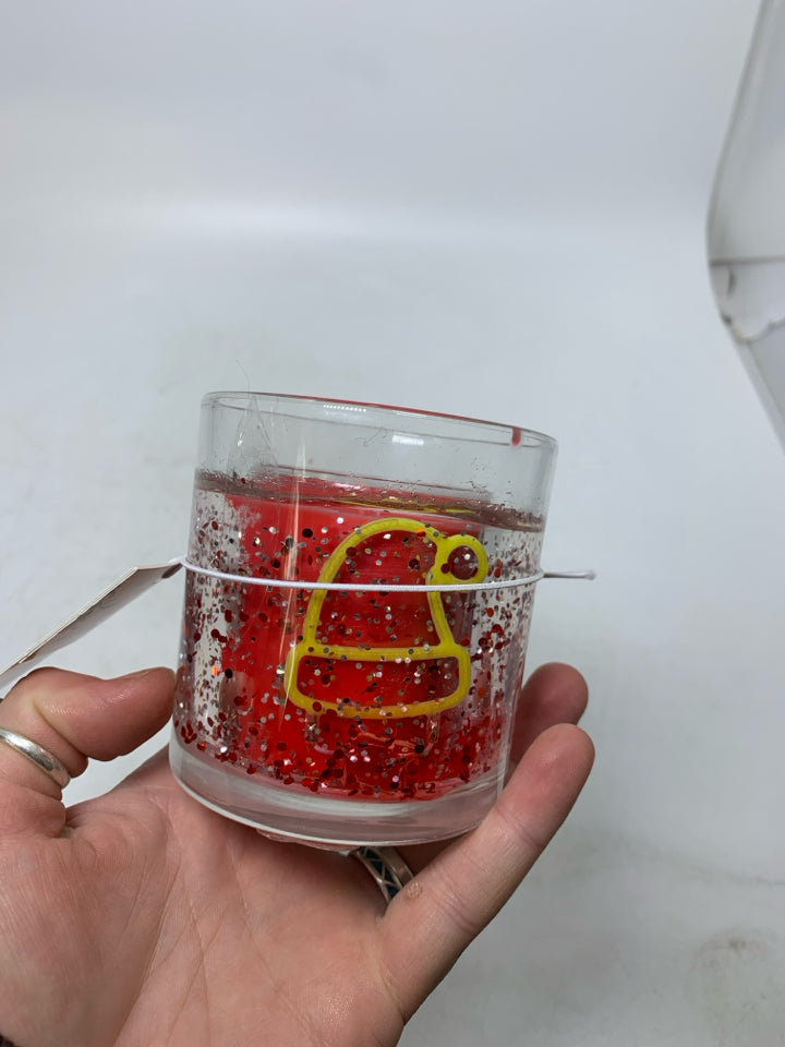 SMALL SANTA THEMED CANDLE.