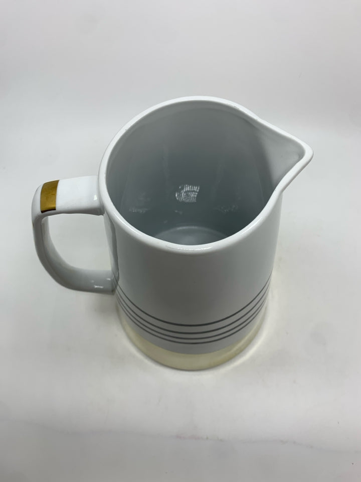 WHITE CERAMIC PITCHER W/BLACK AND GOLD STRIPES.