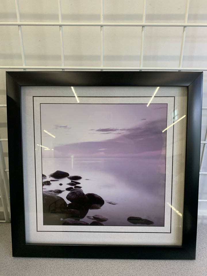 ROCKS ON BEACH PHOTO IN BLACK FRAME.