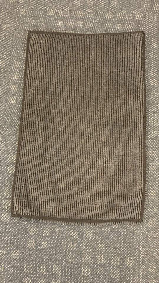BROWN SHAG BATHROOM RUG.