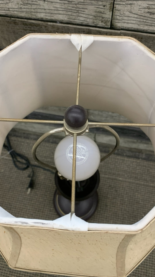 BROWN SCROLL BASE LAMP W/TAN SHADE.