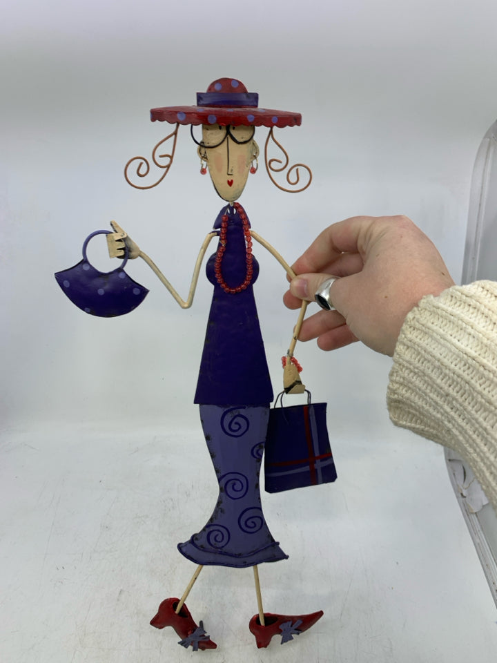 METAL WOMAN IN PURPLE DRESS W/ GLASSES & RED SHOES.