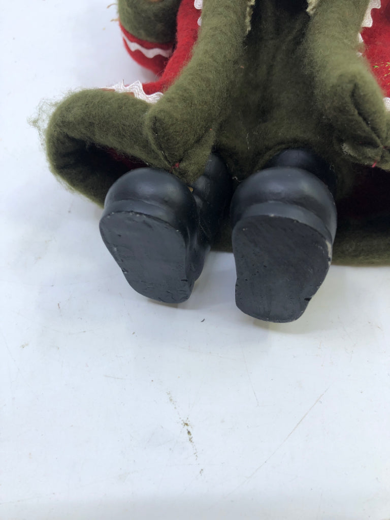 RESIN SANTA W/ RED COAT HOLDING CHRISTMAS TREE.