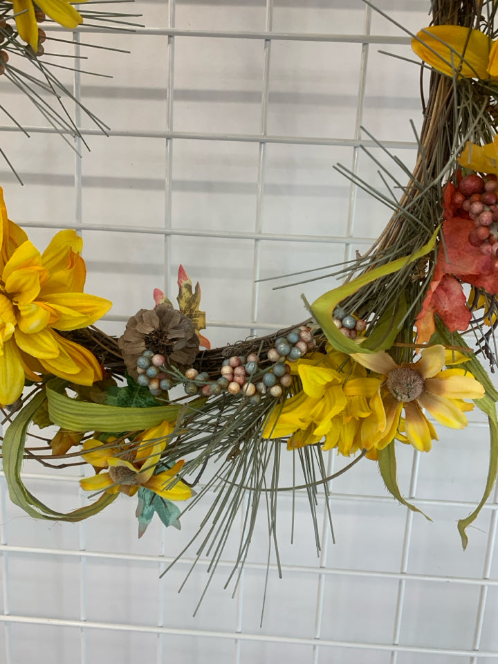 YELLOW FLORAL AND TWIG WREATH.