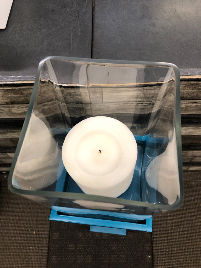 TALL BLUE SQUARE BASE CANDLE HOLDER W/CLEAR GLASS TOP.