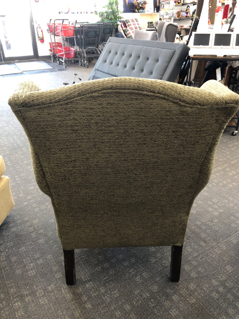 GREEN WING BACK CHAIR W DARK WOOD LEGS.