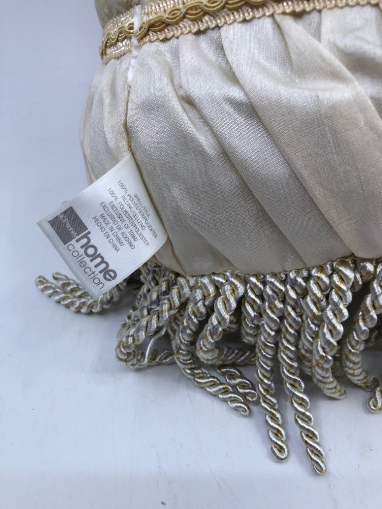 CREAM CYLINDER PILLOW WITH TASSELS.
