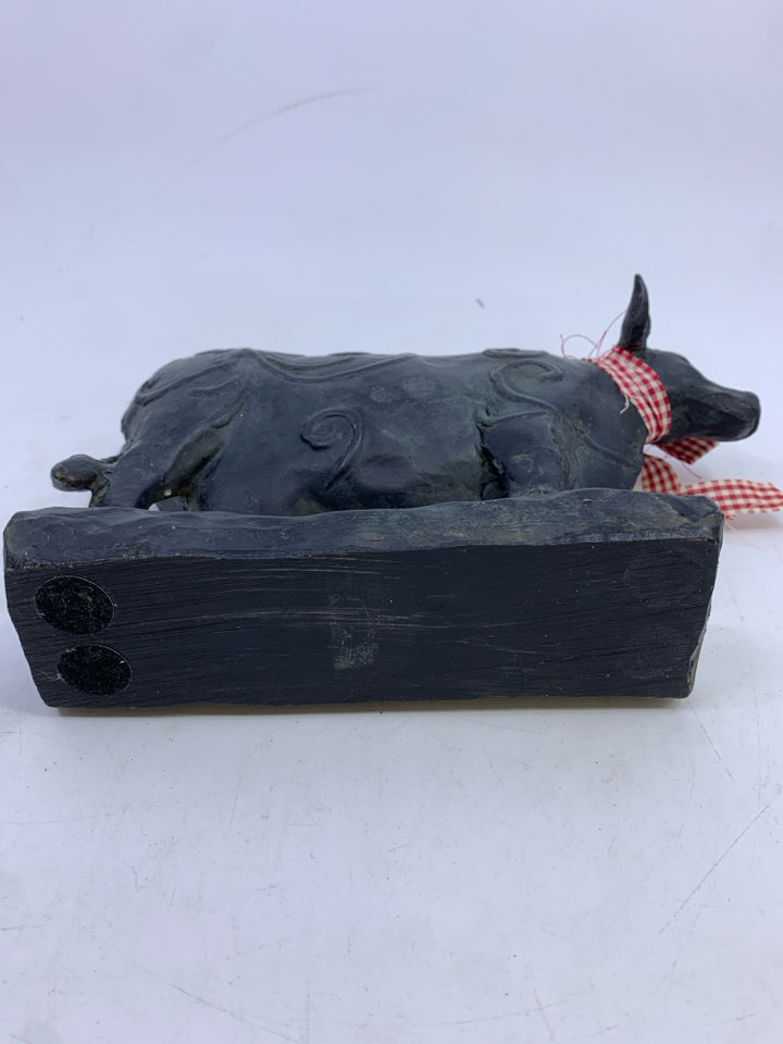 BLACK STANDING COW W/ SWIRL DESIGN.