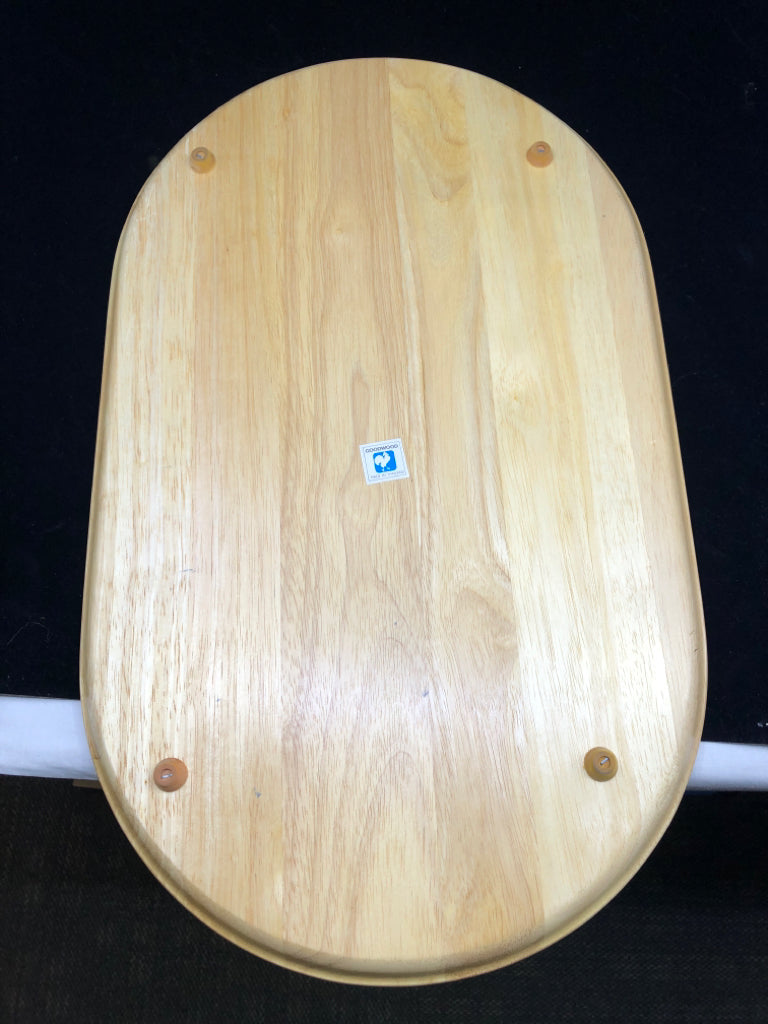 BLONDE OVAL WOOD SERVING TRAY W/ WHITE SQUARE TILE TRIVET IN CENTER.