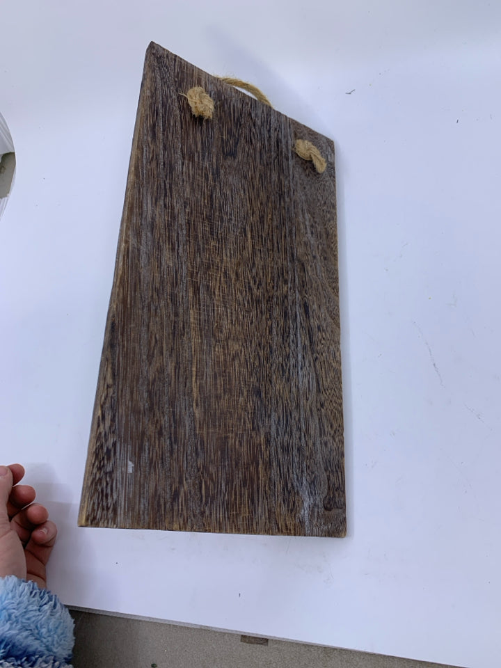 GLASS BOTTLE VASE ON PLANK.
