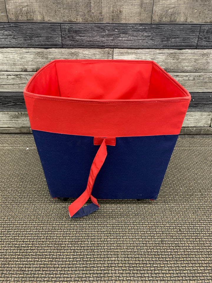 RED CLOTH STORAGE BIN W/WHEELS & HANDLE.