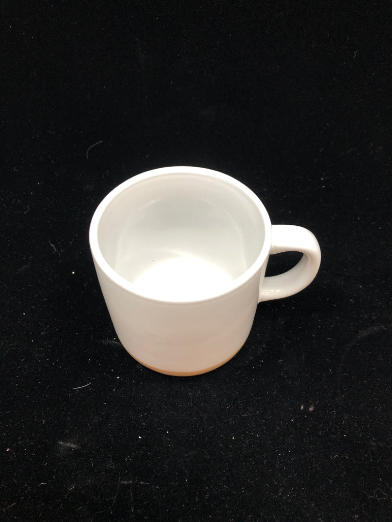 WHITE MUG W/BEIGE BOTTOM.