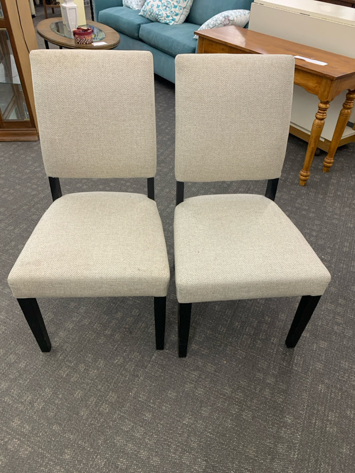 2 CREAM ACCENT CHAIRS W/ BLACK LEGS.