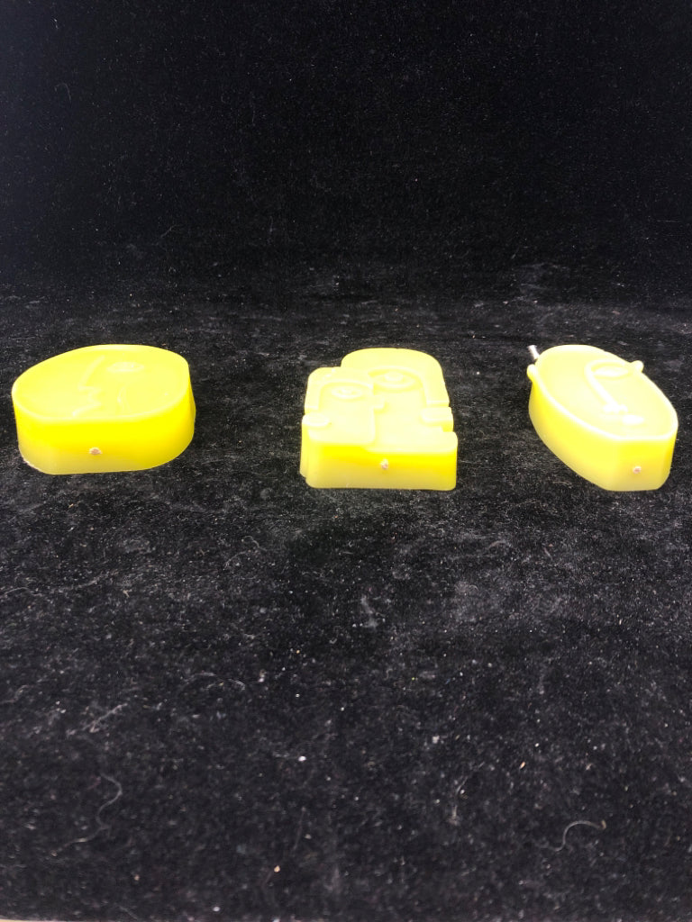3 ABSTRACT FACE SHAPED CANDLES.