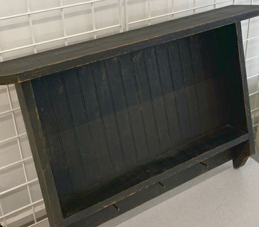 DISTRESSED BLACK WALL SHELF W/ PEG HOOKS.