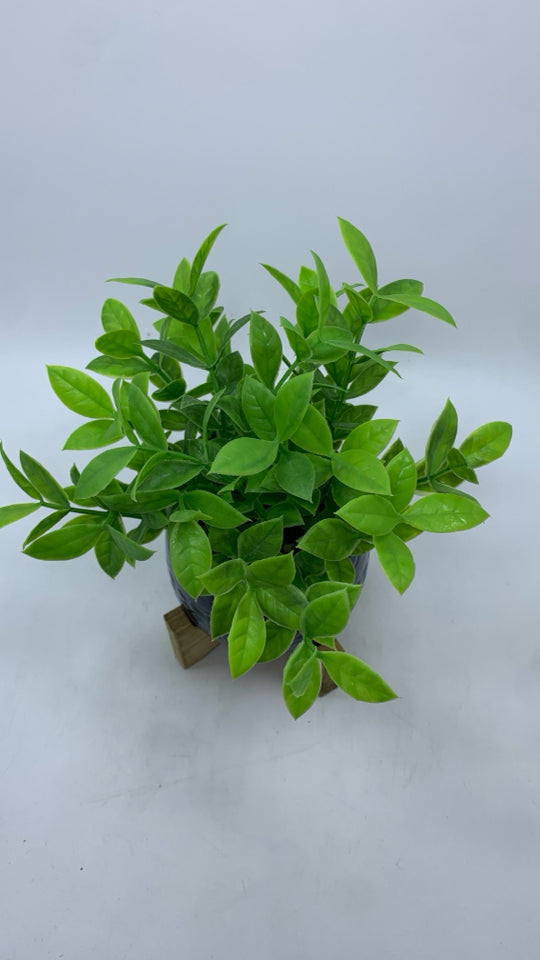FAUX GREENERY IN BLUE RAISED PLANTER.
