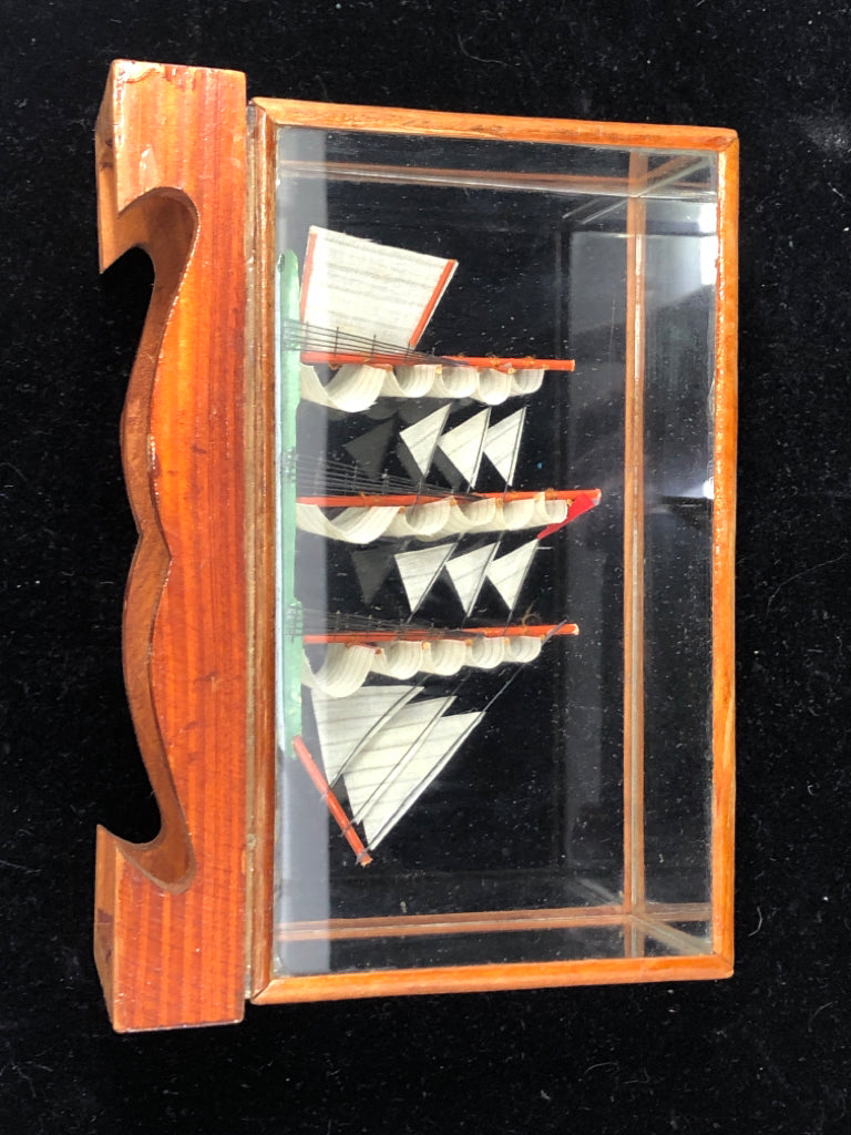 SMALL SHIP IN GLASS CASE.