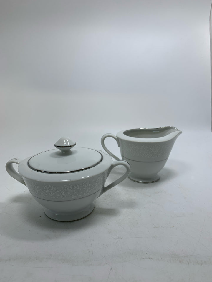 FOOTED WHITE LACE PORCELAIN CREAM/SUGAR SET W/ SILVER DETAILED.