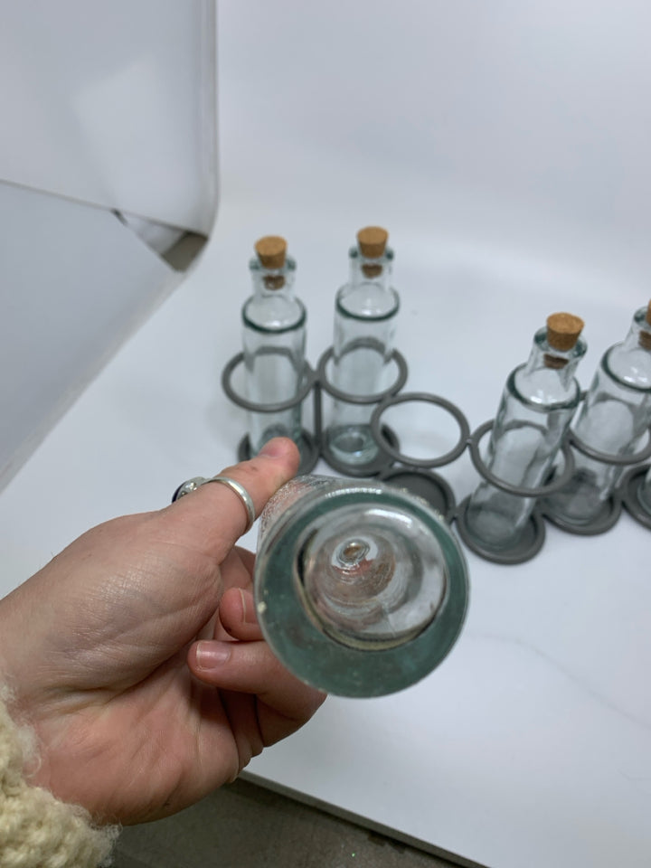 7 SLOT GREY METAL STAND W/ GLASS BOTTLES.