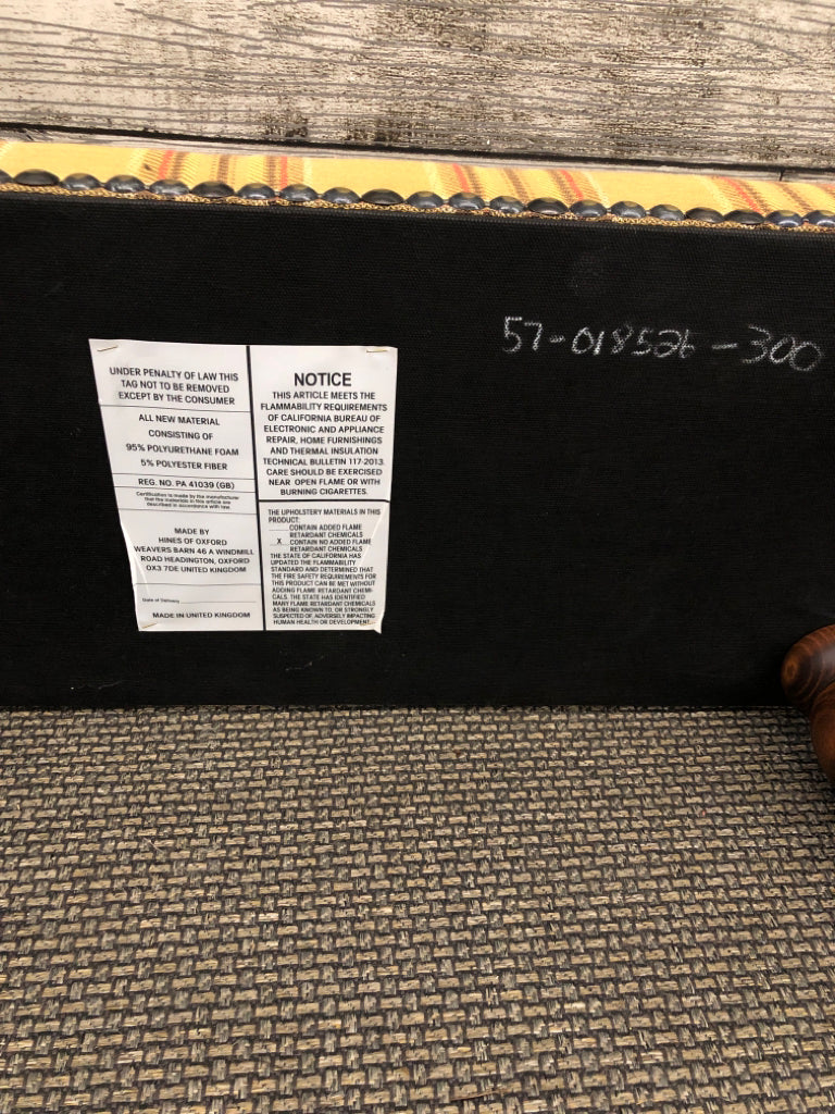 PLAID FOOTSTOOL W/DARK WOOD LEGS.