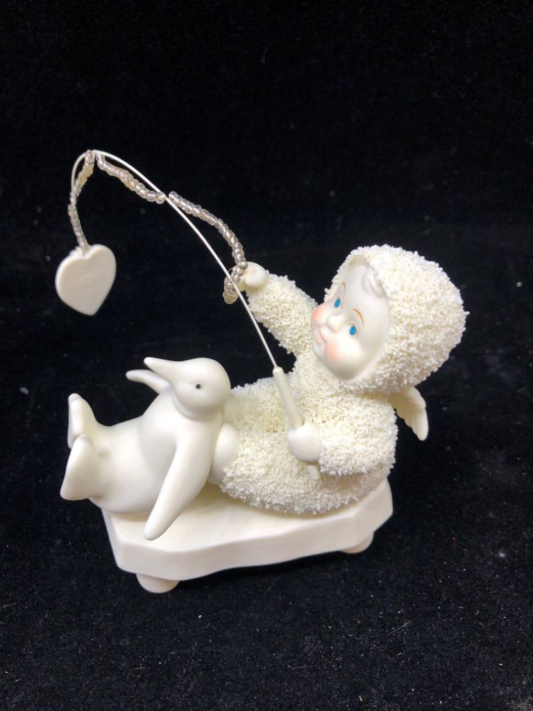 SNOW BABY A SERVANTS HEART HOLDING FISHING POLE.