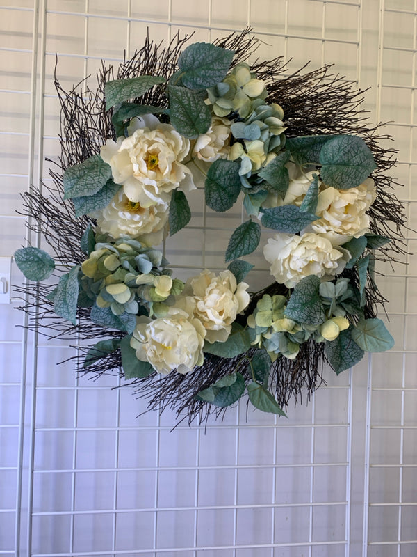 WHITE FLORAL AND GREENERY WREATH.