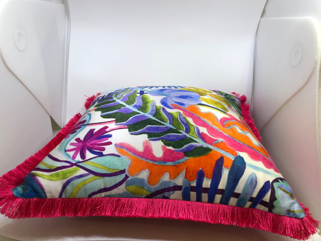 BRIGHT PINK DECORATIVE PILLOW W/FLOWERS AND FRINGE.