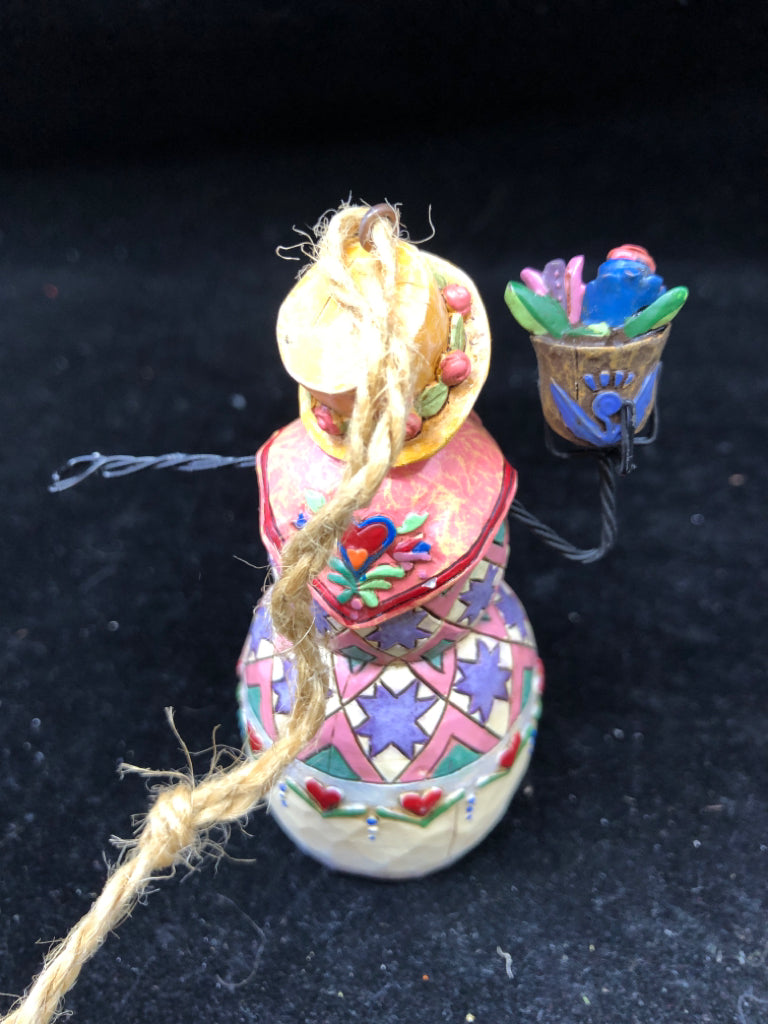 JIM SHORE HOLDING FLOWERS SNOW WOMAN.