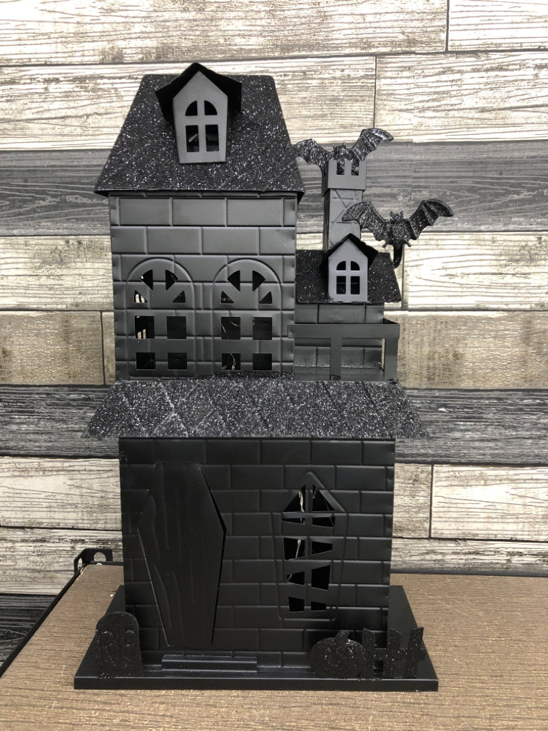 BLACK METAL AND GLITTER LED HAUNTED HOUSE.