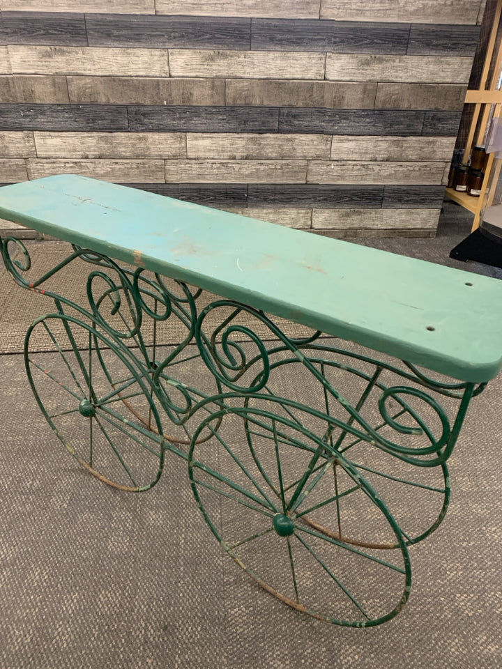 DISTRESSED RUSTIC PLANT STAND W/METAL WHEELS.