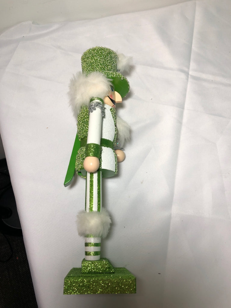 GREEN AND WHITE GLITTER NUT CRACKER.