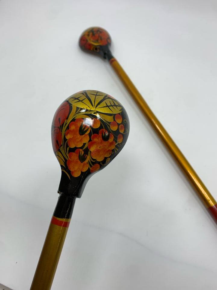 2 GOLD PAINTED LONG HANDLED WOODEN SPOONS.