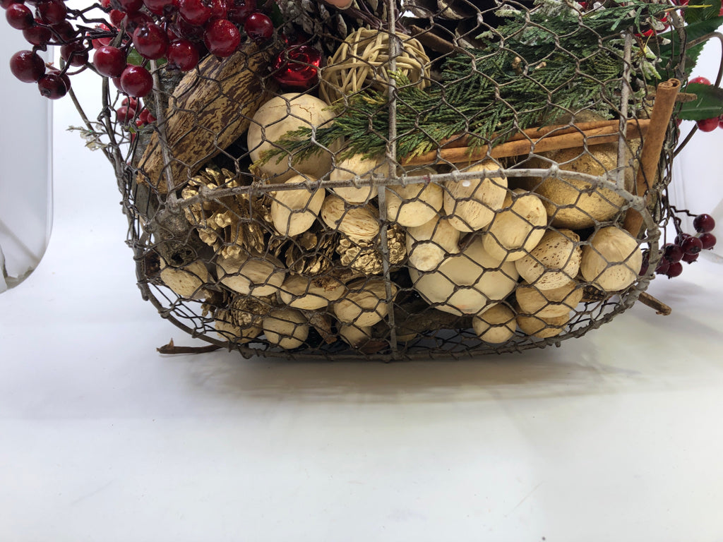 BASKET FULL OF FAUX HOLIDAY ARRANGEMENT.