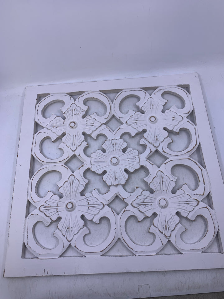 SQUARE WHITE WOOD CUTOUT WALL HANGING.