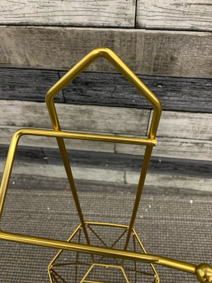 GOLD HEXAGON TOILET PAPER HOLDER.
