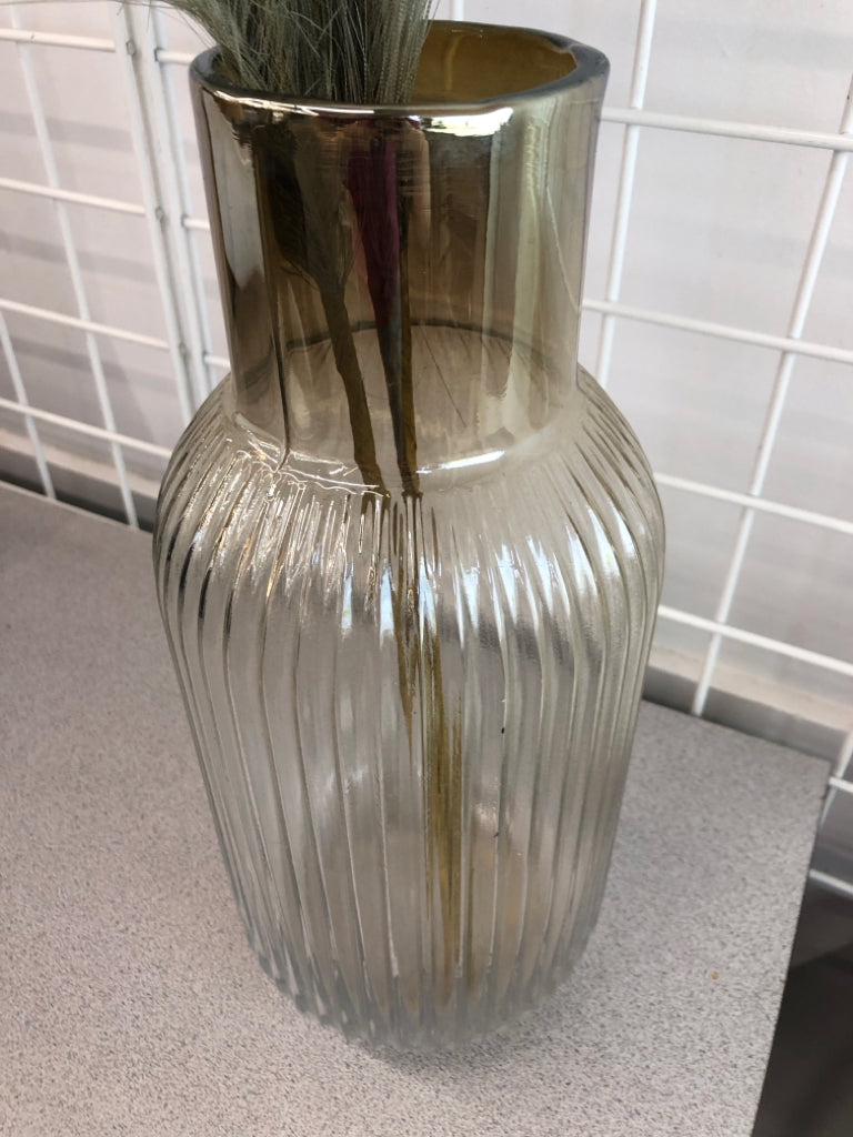 FLUFFY GREEN LEAVES IN GLASS VASE.