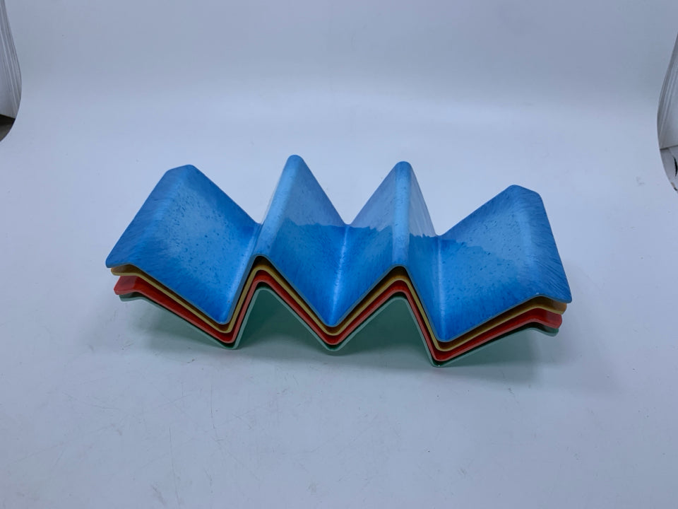 4 PLASTIC ASSORTED COLOR TACO HOLDERS.