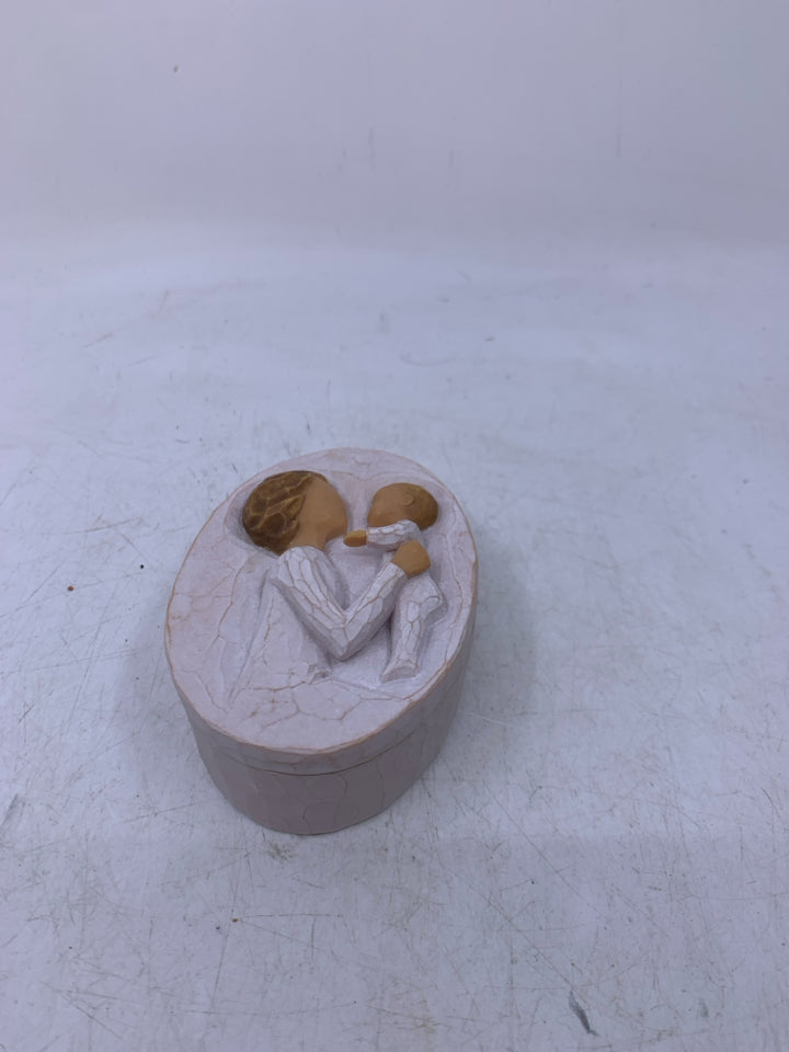 SMALL OVAL GRANDMOTHER HOLDING BABY.