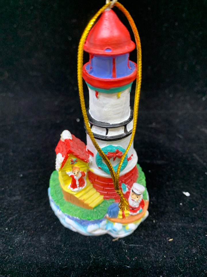 WHITE LIGHTHOUSE ORNAMENT W/SAILING SANTA.