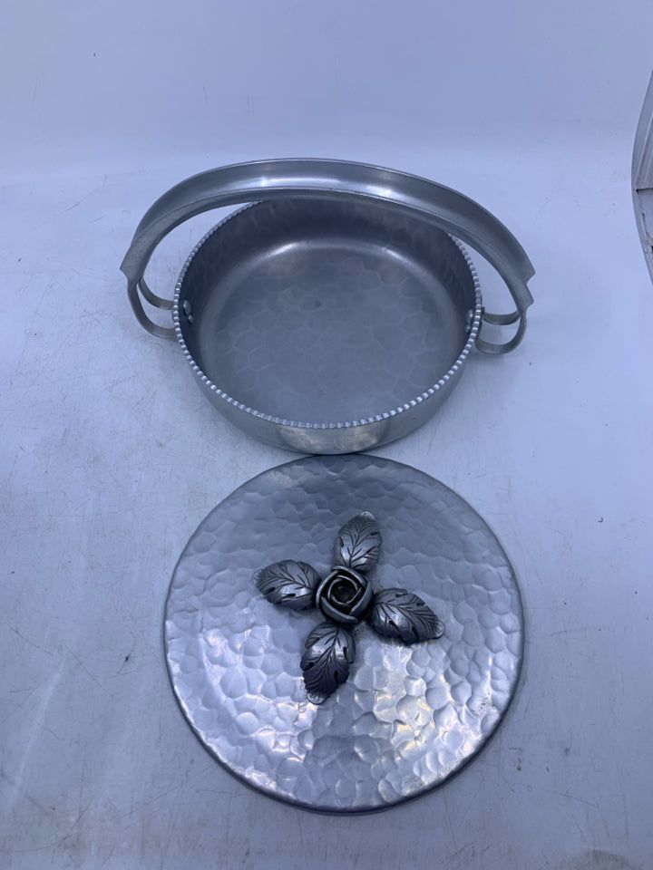 SILVER METAL HAMMERED SHALLOW W/ HANDLE EMBOSSED FLORAL ON LID.