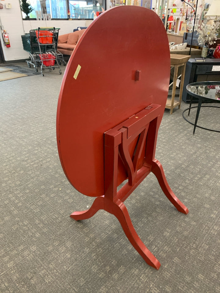 OVAL RED FLIP TOP TABLE.
