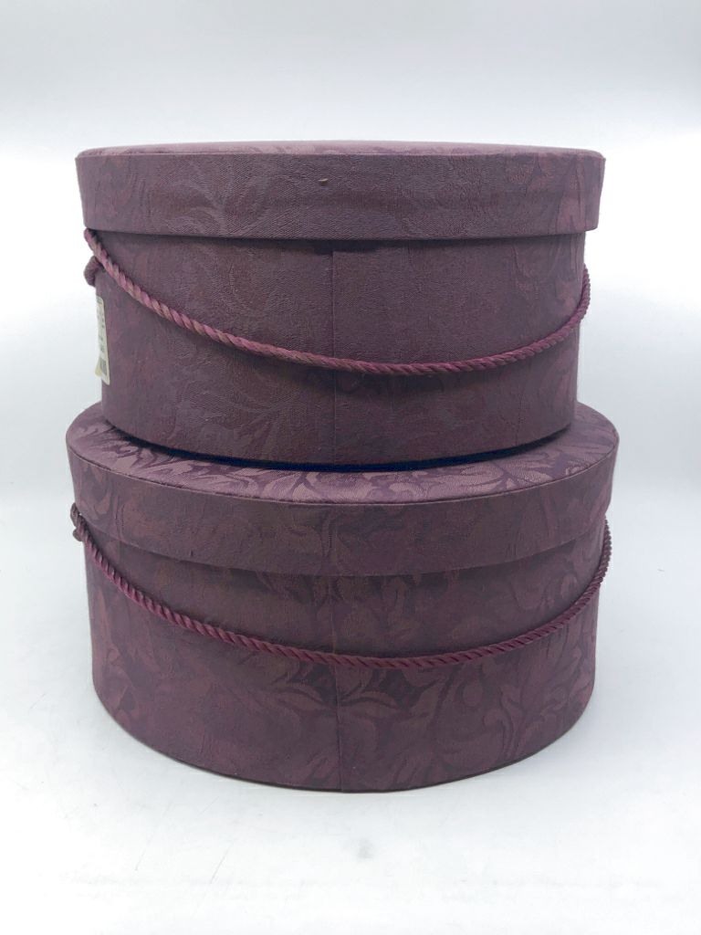 2 NESTING PURPLE FABRIC CIRCLE HAT BOXES.