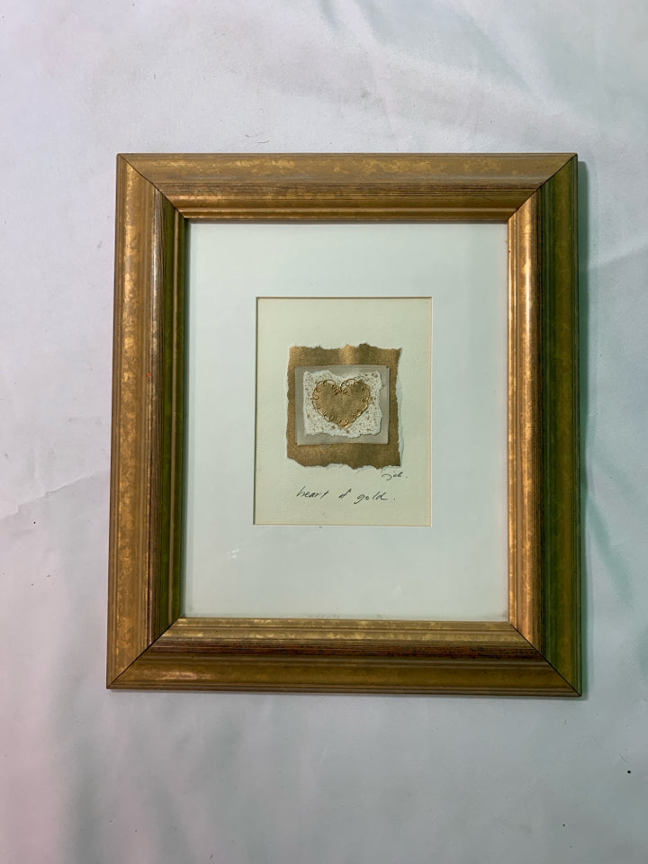 SMALL HEART OF GOLD WALL HANGING IN GOLD FRAME.