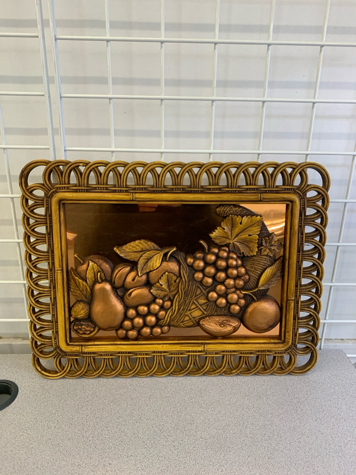 VTG BRONZE FRUIT IN WOVEN PLASTIC FRAME, COPPER BACKGROUND.