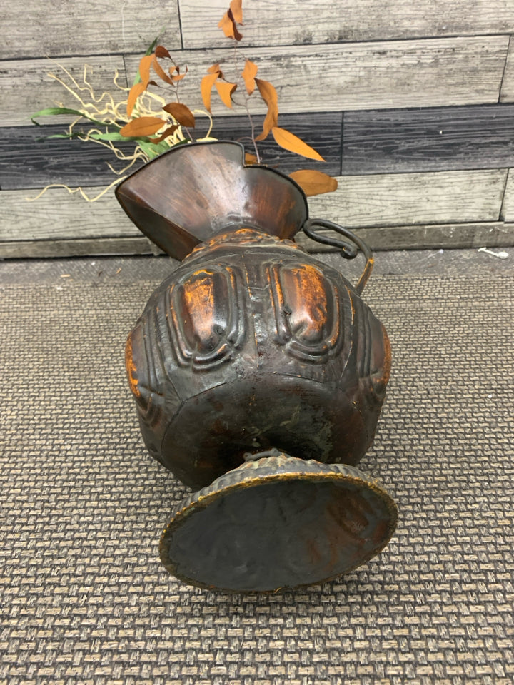 LARGE DISTRESSED METAL PITCHER W FAUX LEAVES.