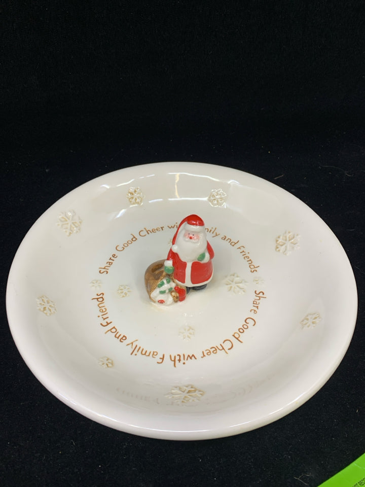 SHARE GOOD CHEER CREAM CERAMIC PLATE WITH RESIN SANTA & TOY BAG IN CENTER.
