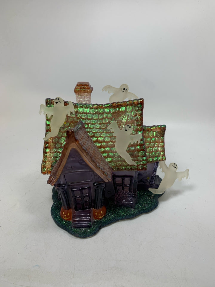 PLASTIC/RESIN PURPLE GHOST HAUNTED HOUSE W/ MUSIC/ FLSHING LIGHTS.