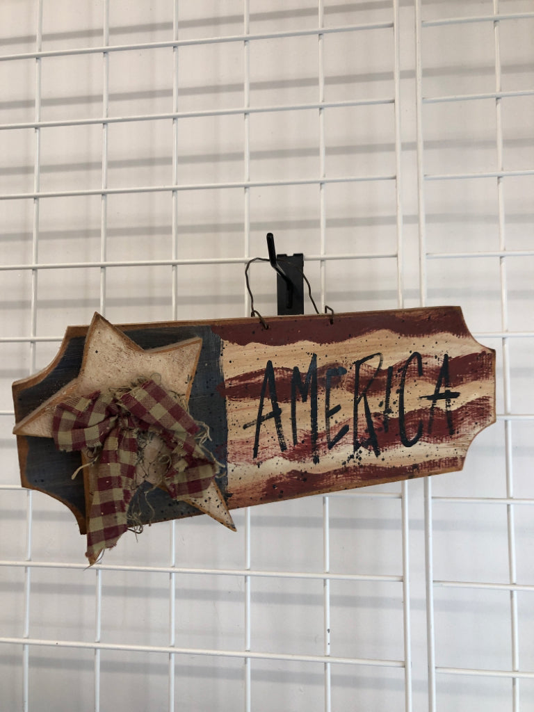 PRIMITIVE AMERICA SIGN W/WOOD STAR AND PLAID BOW.