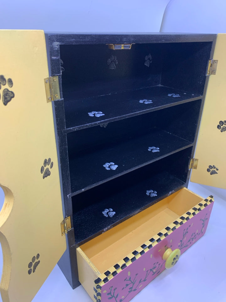 BLACK/WHITE PAINTED CAT W/ YELLOW BACKGROUND W/DRAWER WALL HANGING.